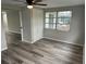 Spacious bedroom with wood-look flooring, ceiling fan, and closet at 3349 Overland Dr, Holiday, FL 34691