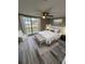 Bedroom with a large window, cozy seating, a ceiling fan and a comfortable bed at 3349 Overland Dr, Holiday, FL 34691