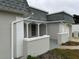 Side view of a single-story house with a gray roof and white and gray walls at 3349 Overland Dr, Holiday, FL 34691