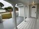 Front entryway with white door and tiled porch at 3349 Overland Dr, Holiday, FL 34691