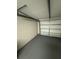 One-car garage interior with white walls and gray flooring at 3349 Overland Dr, Holiday, FL 34691