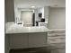 Bright, updated kitchen featuring white cabinetry, quartz countertops, and wood-look flooring at 3349 Overland Dr, Holiday, FL 34691