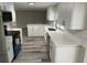 White kitchen with stainless steel appliances, subway tile backsplash, and quartz countertops at 3349 Overland Dr, Holiday, FL 34691