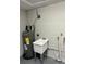 Laundry room with a utility sink, water heater, and washer/dryer hookups at 3349 Overland Dr, Holiday, FL 34691