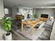 Bright and open living room with dining area, modern furniture, and a view to the kitchen at 3349 Overland Dr, Holiday, FL 34691