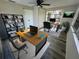 Office featuring dual workstations, a large window and ample storage with a ceiling fan at 3349 Overland Dr, Holiday, FL 34691