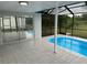 Screened-in pool with sliding glass doors to the home's interior at 3349 Overland Dr, Holiday, FL 34691