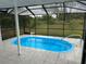 The screened pool area includes steps for easy access at 3349 Overland Dr, Holiday, FL 34691