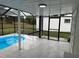 Inviting pool area enclosed by a screen enclosure at 3349 Overland Dr, Holiday, FL 34691
