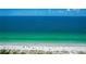 Aerial view of the beach with clear turquoise waters and beachgoers at 341 Bahia Vista Dr, Indian Rocks Beach, FL 33785