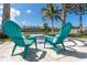 Comfortable teal Adirondack chairs on a waterfront patio at 341 Bahia Vista Dr, Indian Rocks Beach, FL 33785