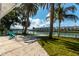 Relaxing backyard patio with waterfront views and lush landscaping at 341 Bahia Vista Dr, Indian Rocks Beach, FL 33785