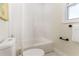 Bright, clean bathroom with a white bathtub, toilet, and shower curtain at 341 Bahia Vista Dr, Indian Rocks Beach, FL 33785