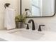 Close-up of a bathroom vanity with modern black faucet and quartz countertop at 341 Bahia Vista Dr, Indian Rocks Beach, FL 33785