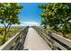 Boardwalk leading to a beautiful beach with umbrellas and beach chairs at 341 Bahia Vista Dr, Indian Rocks Beach, FL 33785