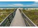 Wooden boardwalk leading to the beach with people enjoying the sand and surf at 341 Bahia Vista Dr, Indian Rocks Beach, FL 33785