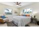 Bright bedroom with large windows, ceiling fan, and stylish furnishings at 341 Bahia Vista Dr, Indian Rocks Beach, FL 33785