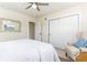 Cozy bedroom with white walls, ceiling fan, and sliding closet doors at 341 Bahia Vista Dr, Indian Rocks Beach, FL 33785