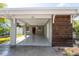 Carport with a wooden accent wall and a view of the front door at 341 Bahia Vista Dr, Indian Rocks Beach, FL 33785