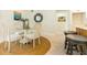 Charming dining area with a round glass table, white chairs, and decorative rug on terrazzo floors at 341 Bahia Vista Dr, Indian Rocks Beach, FL 33785