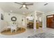 Open-concept dining area adjacent to the kitchen and living room, featuring a ceiling fan at 341 Bahia Vista Dr, Indian Rocks Beach, FL 33785