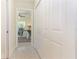 Hallway leading to a bedroom with white closet doors and speckled flooring at 341 Bahia Vista Dr, Indian Rocks Beach, FL 33785