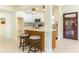 Stylish kitchen with a breakfast bar, white cabinets, and a view of the entryway at 341 Bahia Vista Dr, Indian Rocks Beach, FL 33785