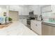 Modern white kitchen with stainless steel appliances and marble countertops at 341 Bahia Vista Dr, Indian Rocks Beach, FL 33785