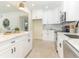 Bright and modern kitchen with white cabinets, marble countertops, and stainless steel appliances at 341 Bahia Vista Dr, Indian Rocks Beach, FL 33785