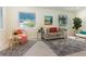 Inviting living room with wicker chairs, a plush sofa, and ample natural light at 341 Bahia Vista Dr, Indian Rocks Beach, FL 33785