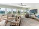 Bright living room with large windows, waterfront views, and comfortable seating at 341 Bahia Vista Dr, Indian Rocks Beach, FL 33785