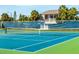 Community tennis court with a net, blue surface, and green surrounding area at 341 Bahia Vista Dr, Indian Rocks Beach, FL 33785