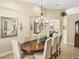 Elegant dining room with a wood table, chandelier, and neutral color palette at 34602 Heavenly Ln, Dade City, FL 33525