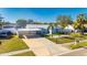 Charming blue home with carport, fenced yard, and palm trees at 412 Flamingo Dr, Apollo Beach, FL 33572