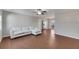 Living room with white sectional sofa, wood-look tile floors, and ceiling fan at 412 Flamingo Dr, Apollo Beach, FL 33572