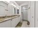 Bright bathroom boasts double sinks with granite counters and a glass-enclosed shower at 4327 Murfield E Dr, Bradenton, FL 34203