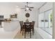 Dining area features a large table with six chairs, a ceiling fan, and sliding doors at 4327 Murfield E Dr, Bradenton, FL 34203