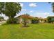 Well-maintained yard with mature landscaping and charming home in the background at 4327 Murfield E Dr, Bradenton, FL 34203