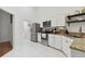 Clean kitchen showcasing stainless steel appliances, granite countertops, and white cabinets at 4327 Murfield E Dr, Bradenton, FL 34203