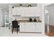 Kitchen featuring granite countertops, white cabinetry, and additional counter space with chair at 4327 Murfield E Dr, Bradenton, FL 34203