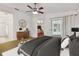 Cozy main bedroom featuring a ceiling fan, a dresser, ensuite bathroom, and access to the lanai at 4327 Murfield E Dr, Bradenton, FL 34203