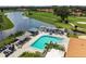 Aerial view of the community pool with ample seating and lake views at 4327 Murfield E Dr, Bradenton, FL 34203