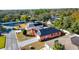 An aerial view of a home with solar panels, surrounded by trees and neighboring houses at 4401 Plumosa St, Spring Hill, FL 34607