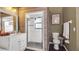 Modern bathroom with glass shower stall and wood-paneled walls at 4401 Plumosa St, Spring Hill, FL 34607