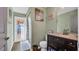 Clean bathroom with dark wood vanity and a door leading to the outdoors at 4401 Plumosa St, Spring Hill, FL 34607