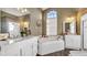 Elegant bathroom featuring a jacuzzi tub, double vanities, and wood accents at 4401 Plumosa St, Spring Hill, FL 34607