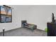 A simple bedroom with a single bed, gray carpet, and large window at 4401 Plumosa St, Spring Hill, FL 34607