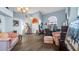 Living room with vaulted ceilings, light blue walls, wood-look flooring, and large windows at 4401 Plumosa St, Spring Hill, FL 34607