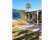 Backyard with covered patio, sea turtle mural, and lush green lawn at 504 79Th Ave, St Pete Beach, FL 33706