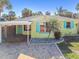 Cute yellow beach house with teal shutters and a carport at 504 79Th Ave, St Pete Beach, FL 33706